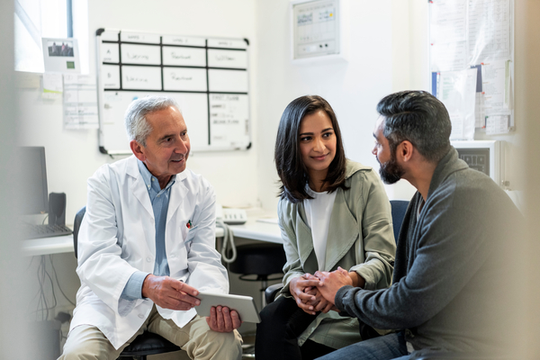 Provider sitting in front of a couple in an office