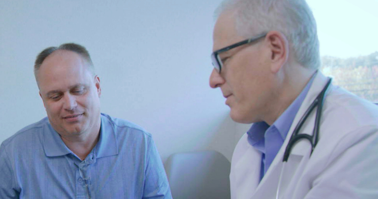 A doctor and patient sitting beside one another